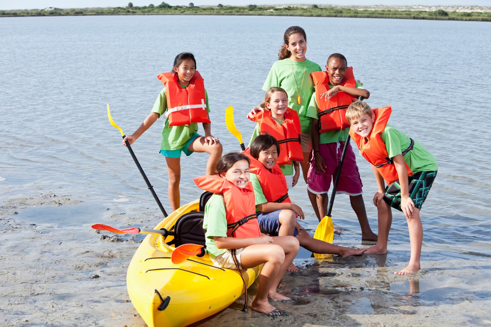 Children in kayaks on the water.